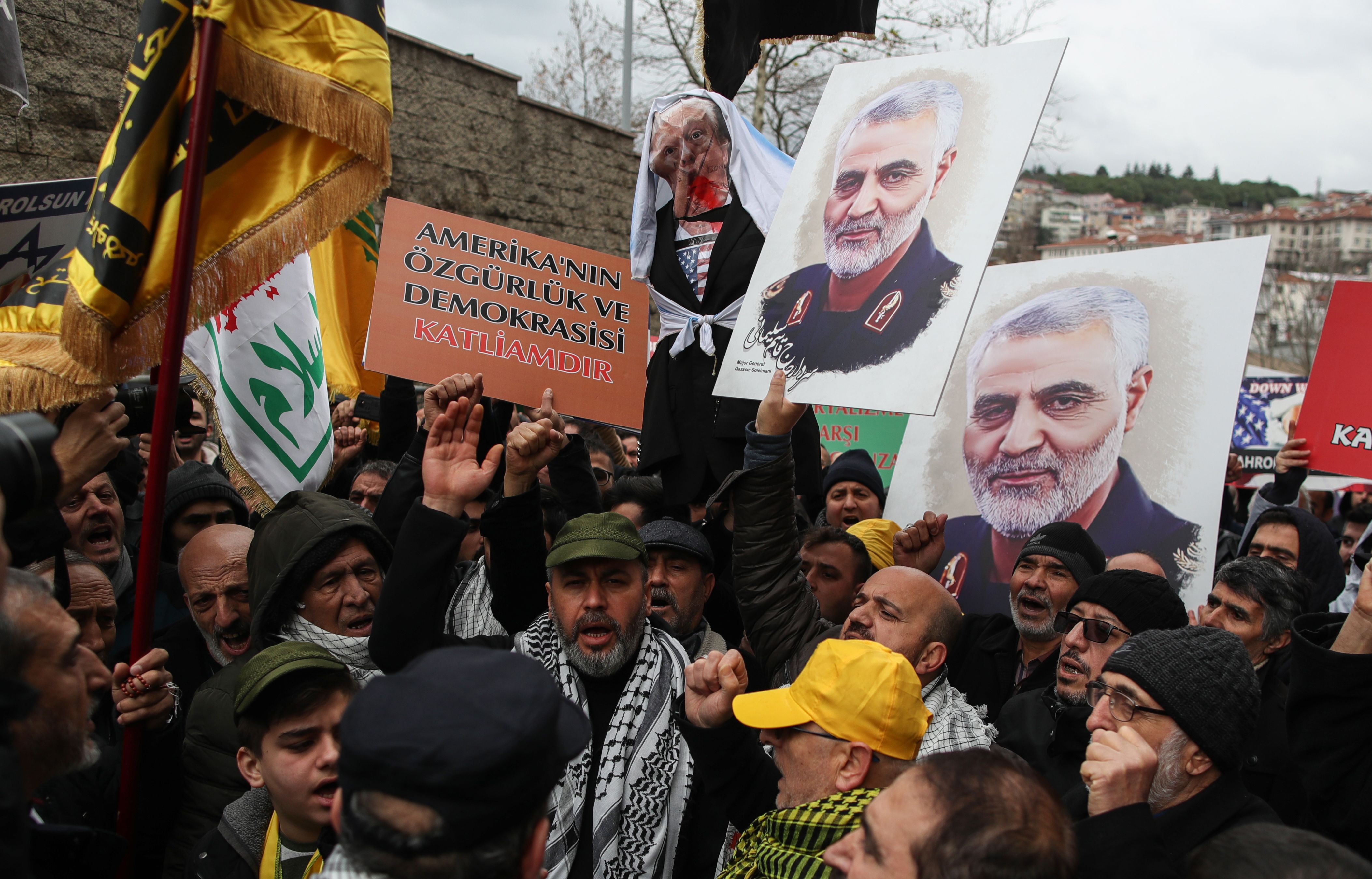 Protesters hold placards showing a portrait of slain Iranian Revolutionary Guards Corps (IRGC) Lieutenant general and commander of the Quds Force Qasem Soleimani and effigy of US President Donald Trump during a demonstration in front of the US consulate in Istanbul, Turkey.