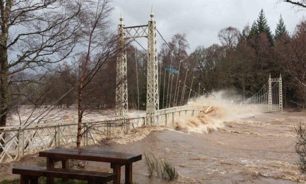 The Cambus O'May footbridge over the River Dee during Storm Frank in 2015