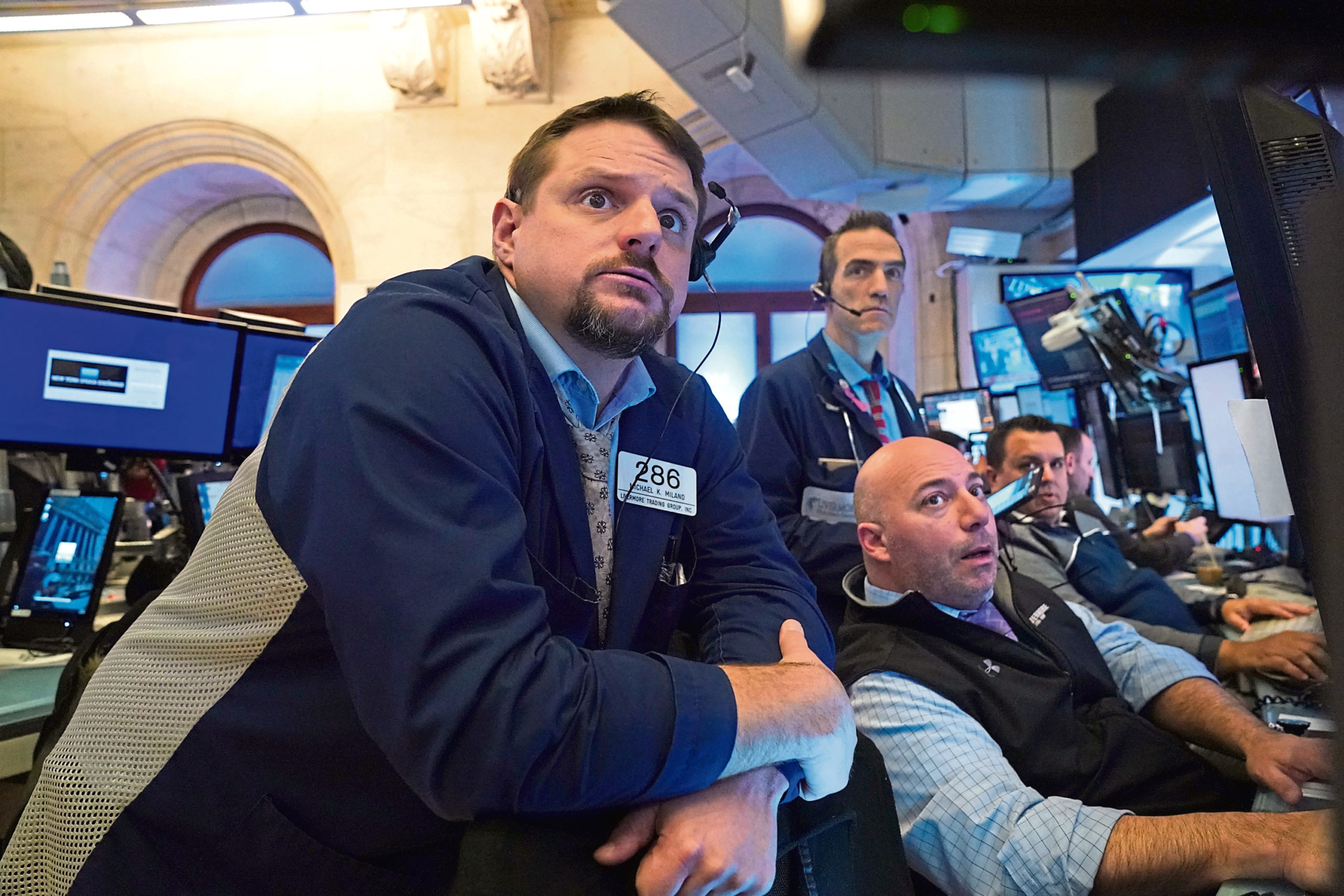 Traders work on the floor at the closing bell of the Dow Industrial Average at the New York Stock Exchange.