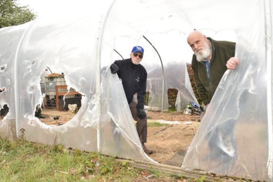 The Inverurie and District men's shed has been vandalised, yet again. - members Leith Robertson and Jim Smith inspect the damage.(2019)