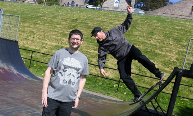 Skaters showing off their tricks at the current park.