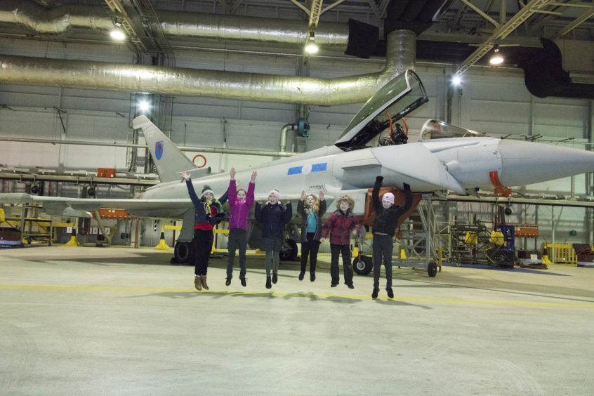 Takeoff! STEM winners having fun in front of one of the Typhoons