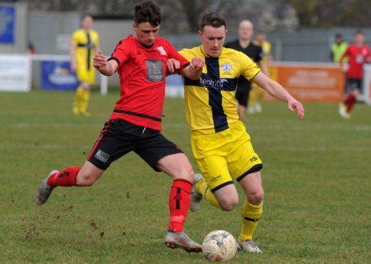 Wick Academy's Gary Manson (right) in action against Inverurie Locos