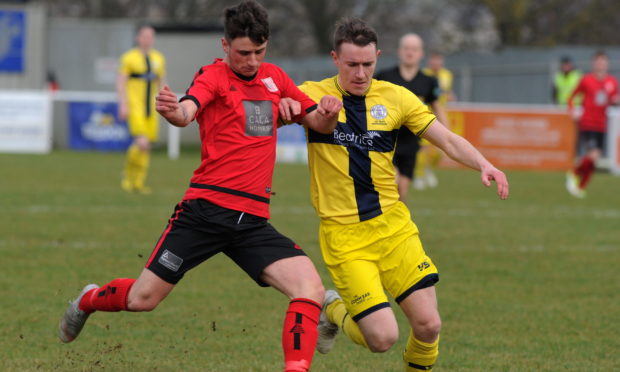 Wick Academy's Gary Manson (right) in action against Inverurie Locos