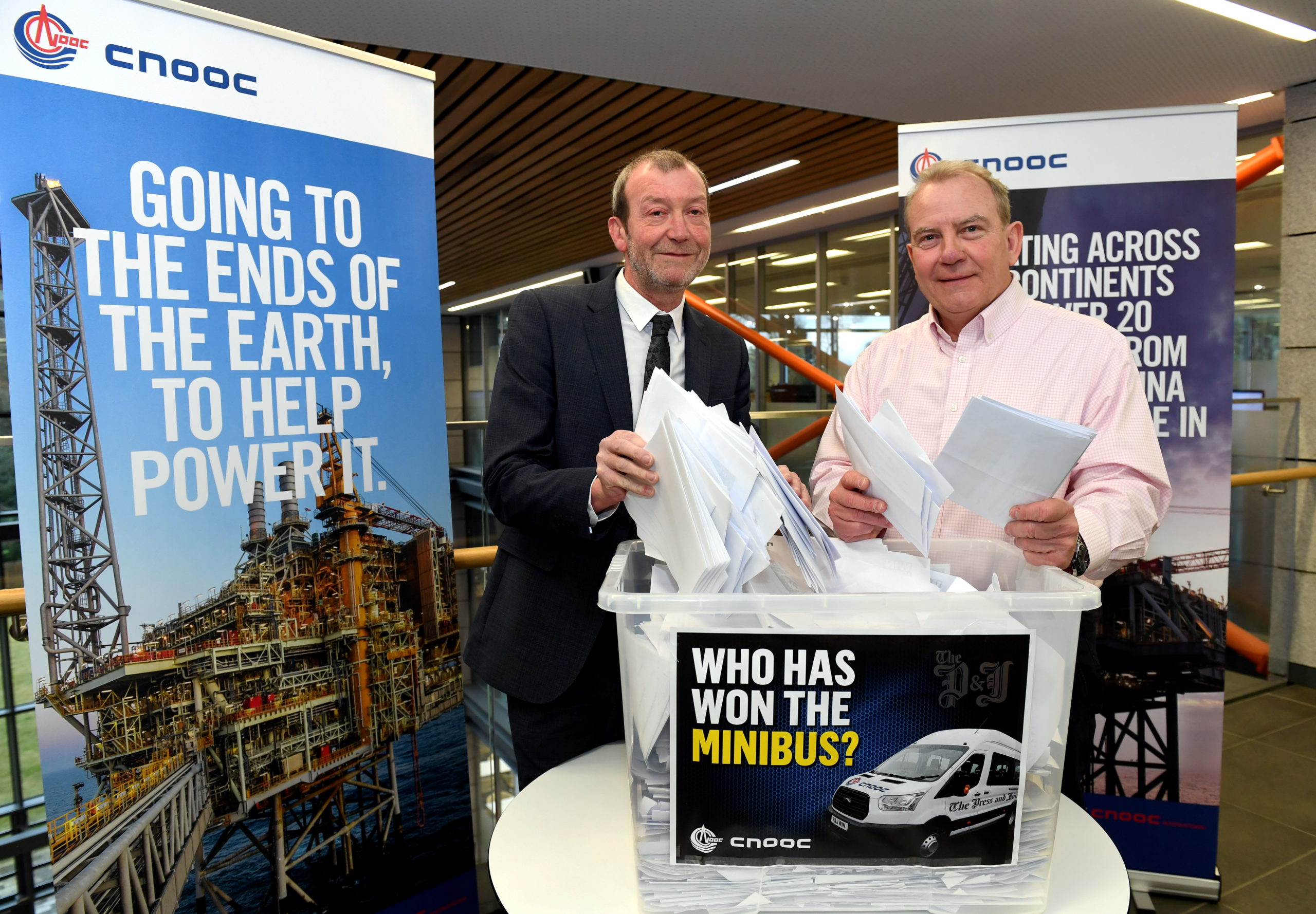 Press and Journal Deputy Editor Andrew Kellock along with CNOOC International MD & Senior VP Europe & Africa Ray Riddoch make the draw for the P&J minibus competition.
Picture by Kami Thomson