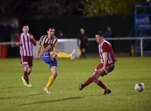 Locos captain Neil McLean, centre has a shot on goal.
Picture by Scott Baxter