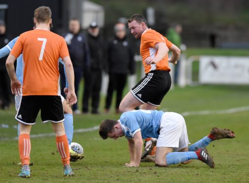 Rothes defender Paul Macleod (centre).