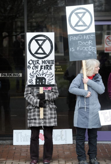 Climate activists protest outside the Highland Council headquarters in Inverness.
Picture by Sandy McCook.