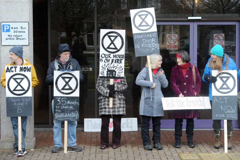 Climate activists protest outside the Highland Council headquarters in Inverness.
Picture by Sandy McCook.