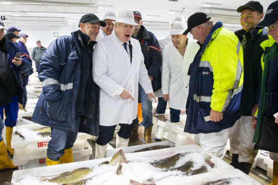 Boris Johnson during a visit to Peterhead fish market.