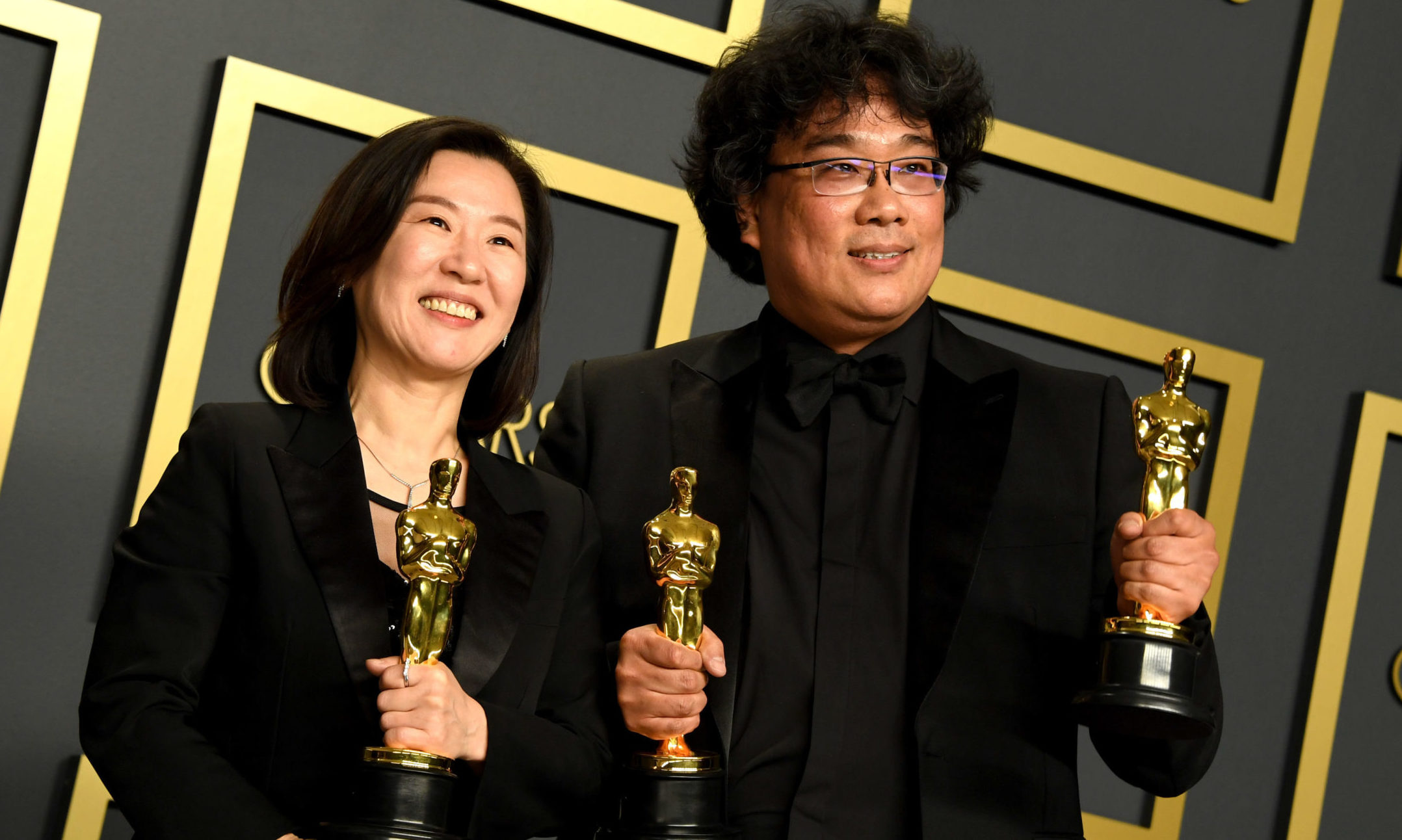 Bong Joon-ho (right) and Kwak Sin-ae with their Oscars for Best Original Screenplay, International Feature Film, Best Director, and Best Picture for Parasite in the press room at the 92nd Academy Awards held at the Dolby Theatre in Hollywood, Los Angeles.