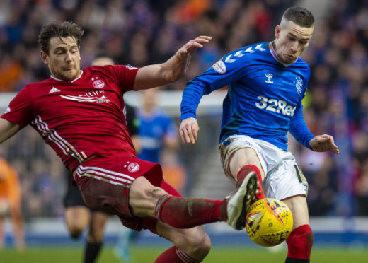 Ash Taylor (left) tackles Rangers winger Ryan Kent