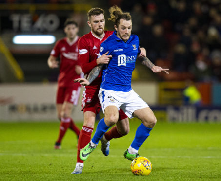 Michael Devlin challenges St Johnstone's Stevie May