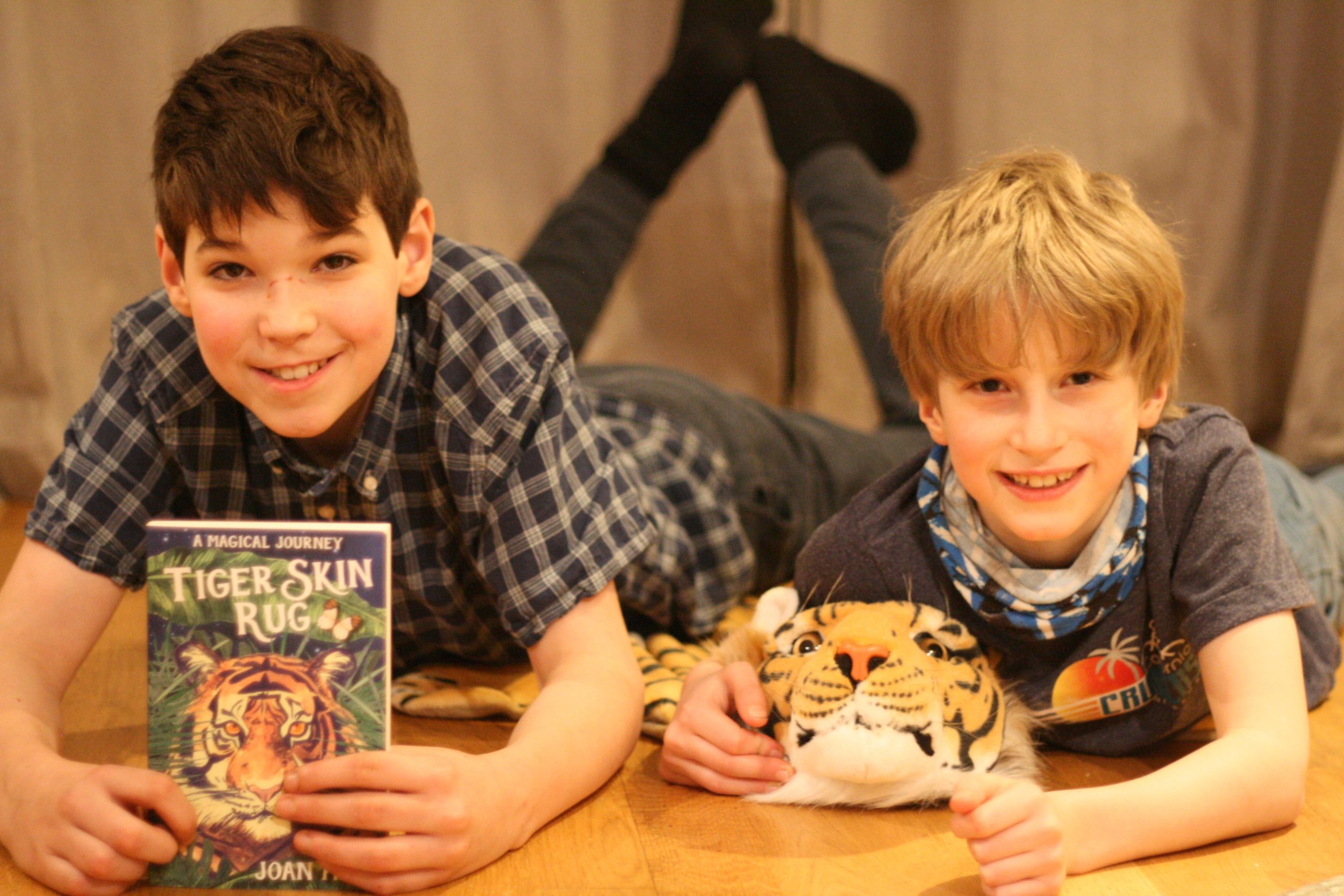 Joan Haig's kids Andrew (11) and Adrian (9) with her novel Tiger Skin Rug.