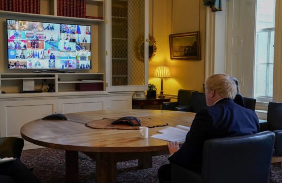 Boris Johnson in the study of No 10 Downing Street, on a video conference call to other G20 leaders during the coronavirus. Picture by Andrew Parsons/ No 10 Downing Street