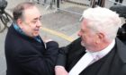 Alex Salmond elbow bumps Gordon Jackson QC as he leaves the High Court in Edinburgh.