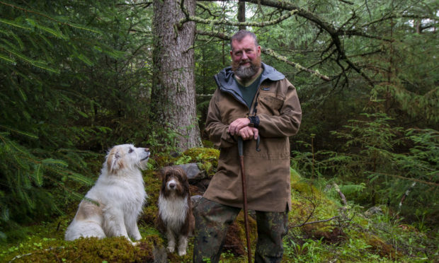 Duncan Bain MacKenzie, descendant of one of the clearance families stands amongst the Inverlael township ruins