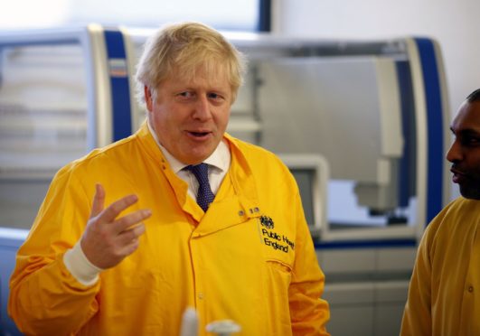 Prime Minister Boris Johnson  visits a laboratory at the Public Health England National Infection Service in Colindale, north London, as the number of confirmed coronavirus cases in the UK leapt to 35 after 12 new patients were identified in England. PA Photo. Picture date: Sunday March 1, 2020. See PA story HEALTH Coronavirus. Photo credit should read: Henry Nicholls/PA Wire