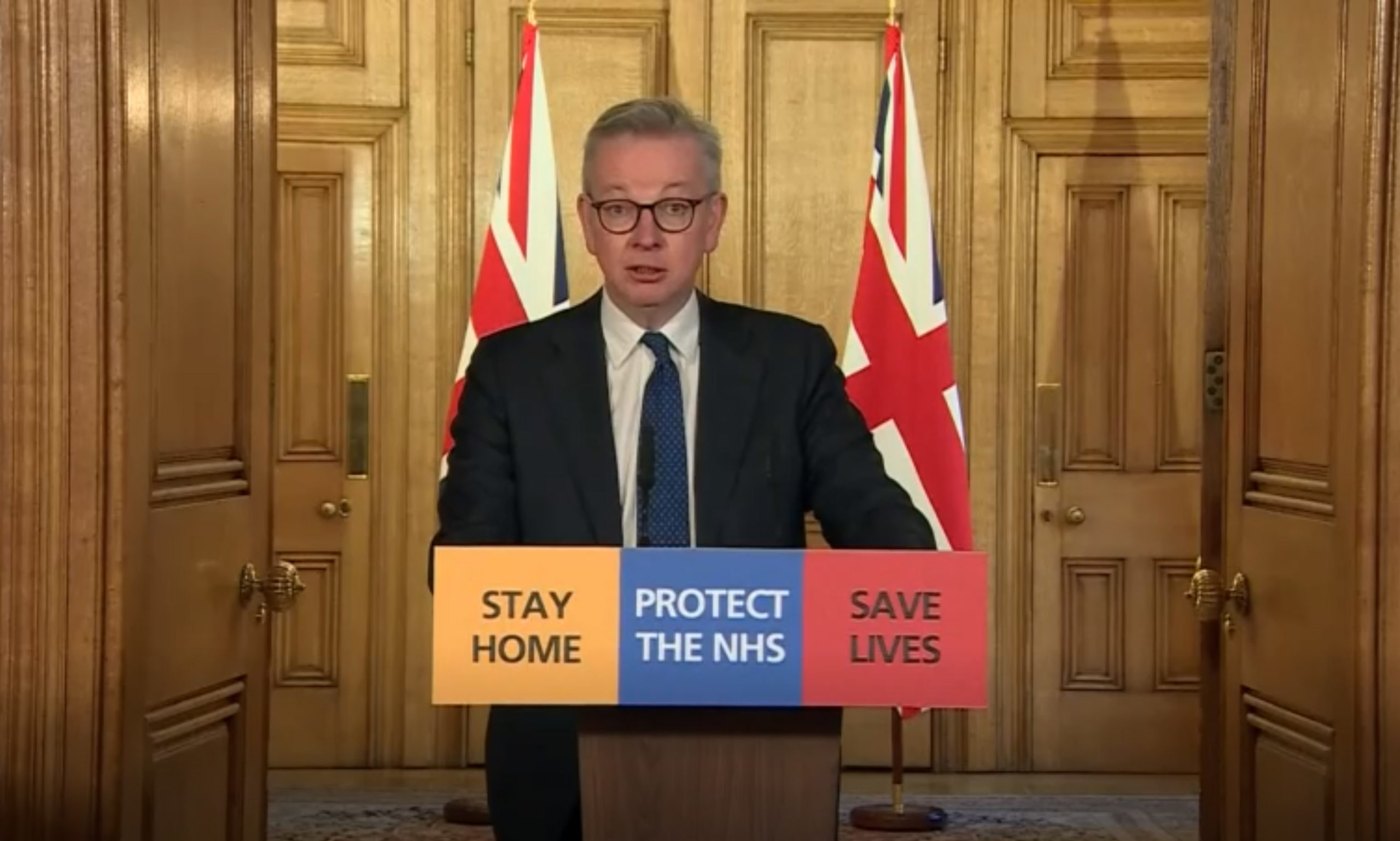 Michael Gove answering questions from the media via a video link during a media briefing in Downing Street.