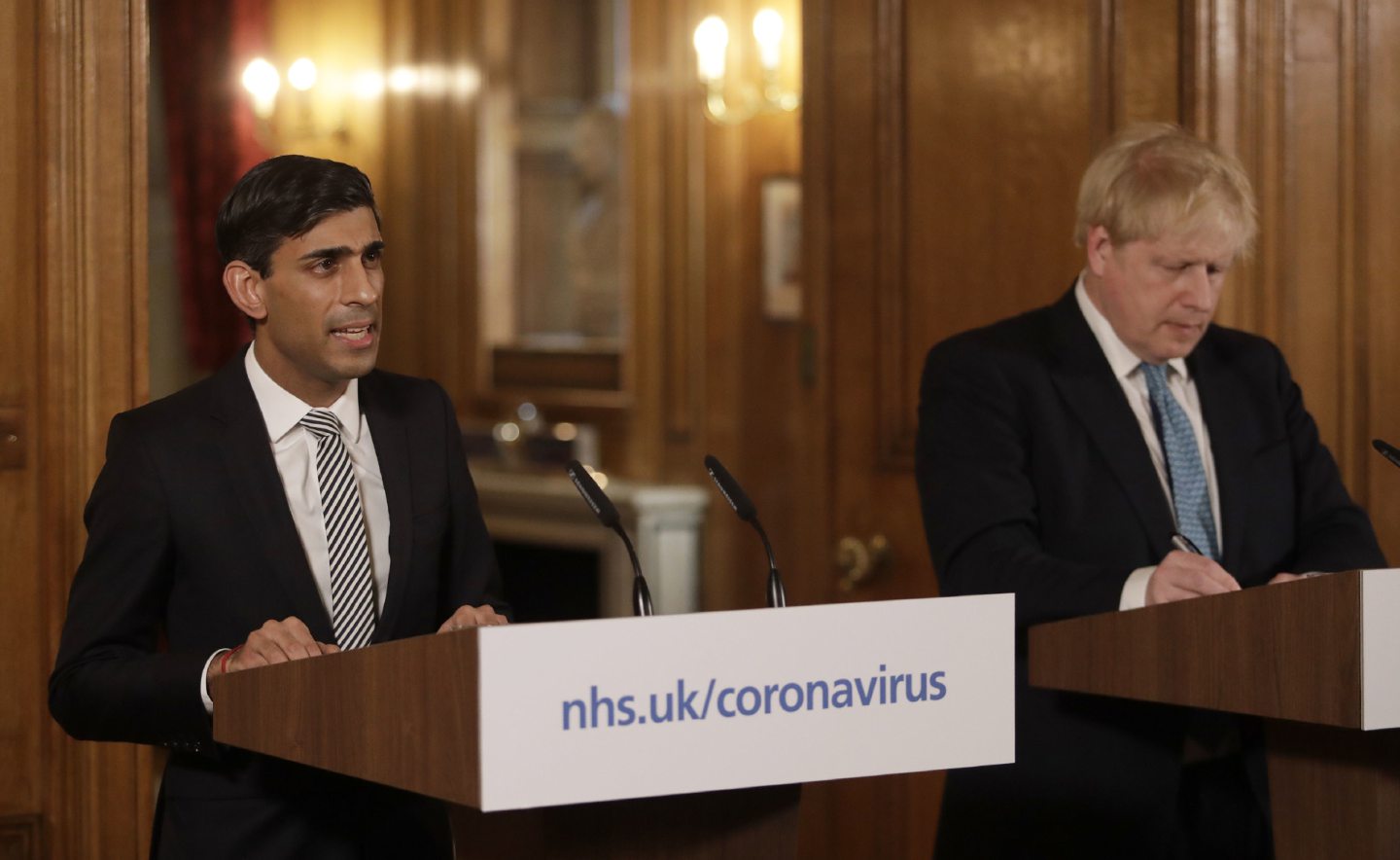 Chancellor Rishi Sunak with Prime Minister Boris Johnson at a media briefing in Downing Street, London, on Coronavirus (COVID-19). Picture date: Tuesday March 17, 2020. See PA story HEALTH Coronavirus. Photo credit should read: Matt Dunham/PA Wire