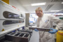 Clinical support technician Douglas Condie extracts viruses from swab samples so that the genetic structure of a virus can be analysed and identified in the coronavirus testing laboratory at Glasgow Royal Infirmary, Glasgow. Picture by Jane Barlow/PA