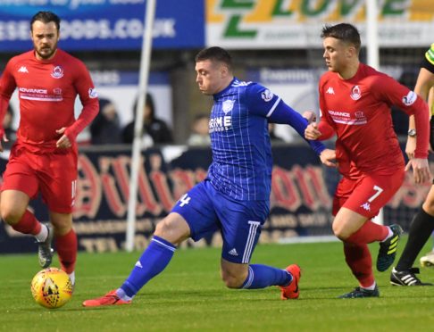 Gary Fraser, centre, in action for Peterhead.