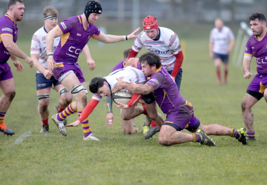 Grammar's Craig Shepherd is brought down before the tryline.
Picture by Kath Flannery