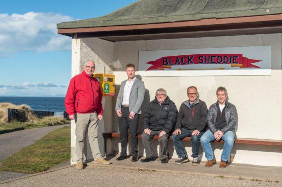 Campaigners in Hopeman are celebrating the installation of a lifesaving defibrillator at the village's harbour. Pictured: Hopeman Community Association chairman, Dennis Slater, Blair Tulloch, architect from Tulloch of Cummingston, volunteer Jack Burke, electrical fitter Donald Beattie, community association vice-chairman Murray Easton.