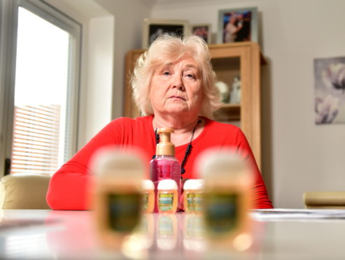 Dorothy Elder with hand sanitiser brought back from the states.
Picture by Scott Baxter