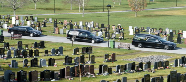 The cortege arrives at the cemetary for the commital.