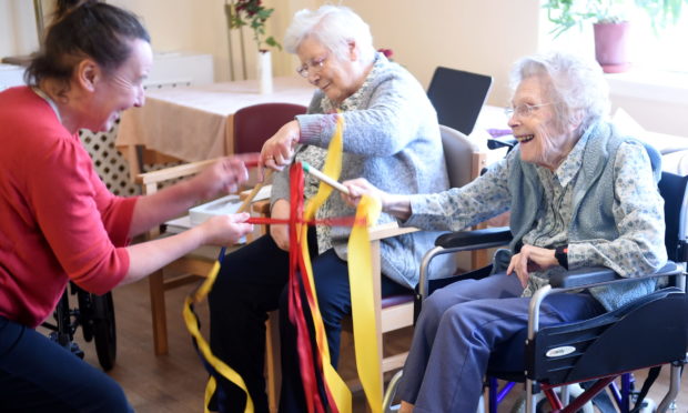 Residents of Whinnieknowe residential care home, Nairn enjoy exercise to dance music. Picture by Sandy McCook