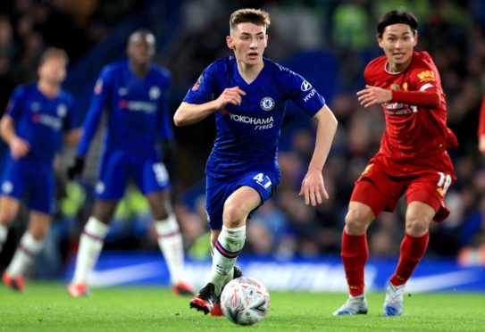 Chelsea's Billy Gilmour (centre) controls the ball away from Liverpool's Takumi Minamino (right) during an FA Cup fifth-round match at Stamford Bridge, London.