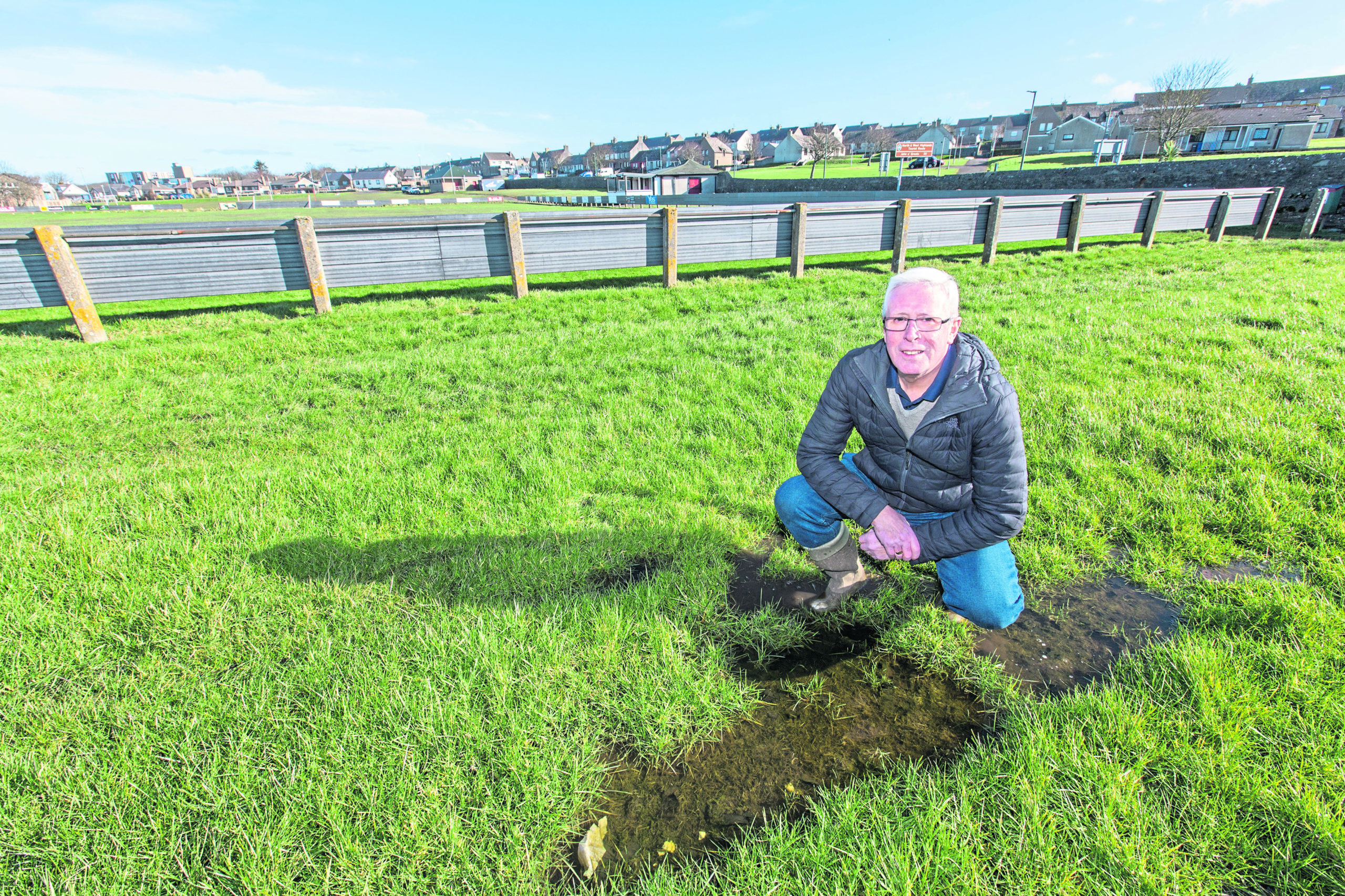 Murray Coghill, president of Caithness Amateur Football Association, checks one of the water logged areas of the pitch at The Dammies, Thurso. Picture by Robert MacDonald/Northern Studios.