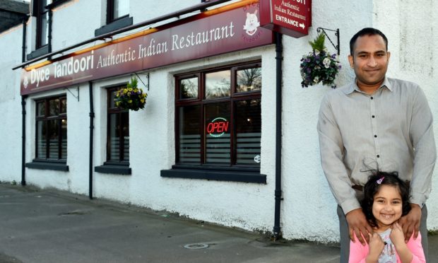 Nafiz Hasan with daughter Naureen, outside Dyce Tandoori.
Picture by COLIN RENNIE