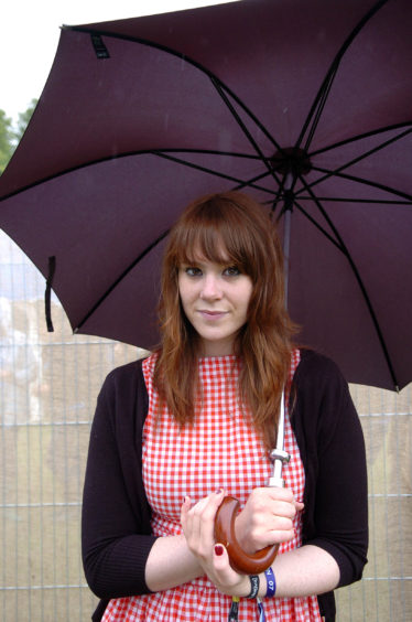 Kate Nash sheltering from the rain under an umbrella shortly before her popular performance. Picture by Andrew Duke.