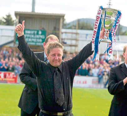 ICT manager John Robertson lifts the First Division trophy in 2004.