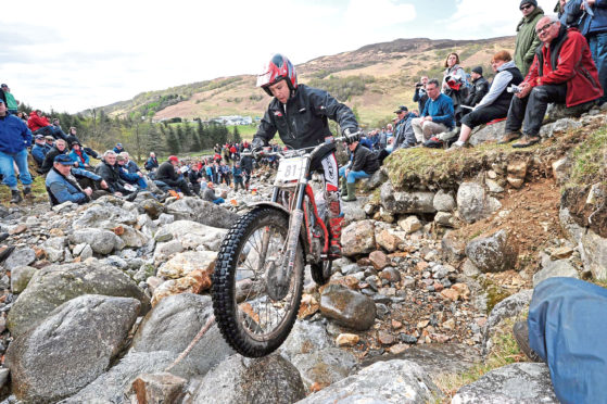 New reality: Spectators watch rider Gary MacDonald competing in one of the previous Six Day Trials annual motorcycle competitions