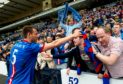 Gary Warren celebrates with the Caley Thistle fans after beating Celtic.