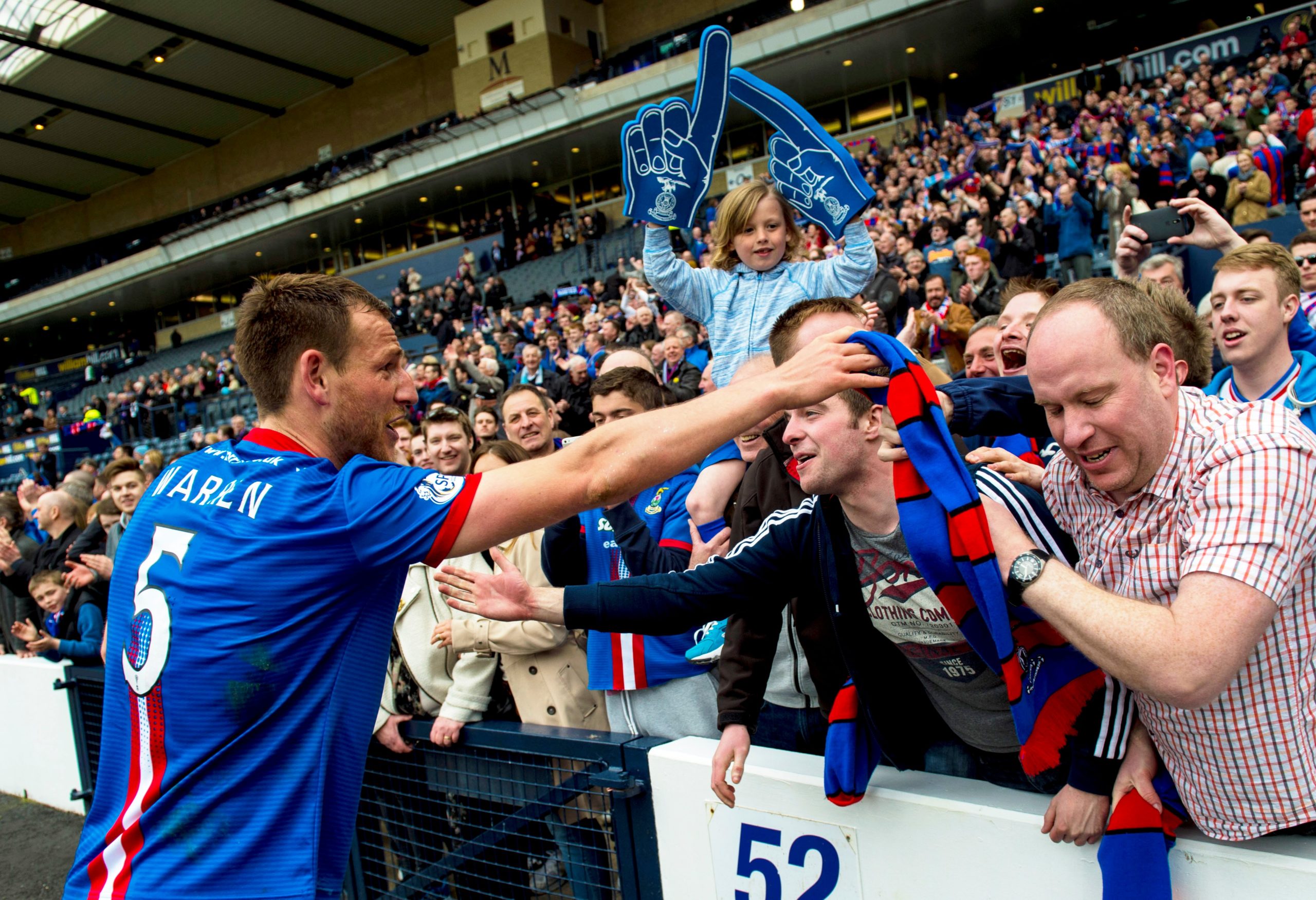 Gary Warren celebrates with the Caley Thistle fans after beating Celtic.