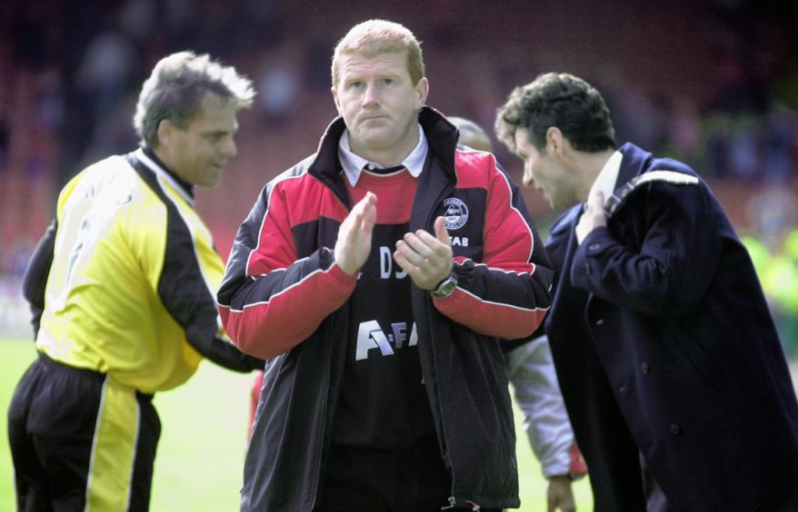Kjaer shakes hands with boss Steve Paterson after his final game, which came against Partick Thistle at home in 2003.