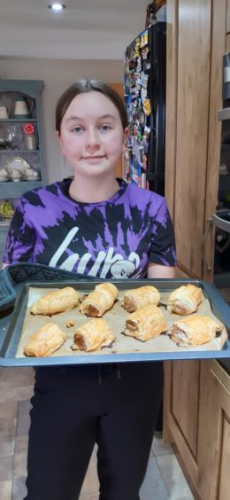 Carrie Duncan, 12, from King Edward, making sausage rolls for tea