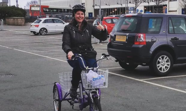 Councillor Emma Roddick on her loaned e-trike