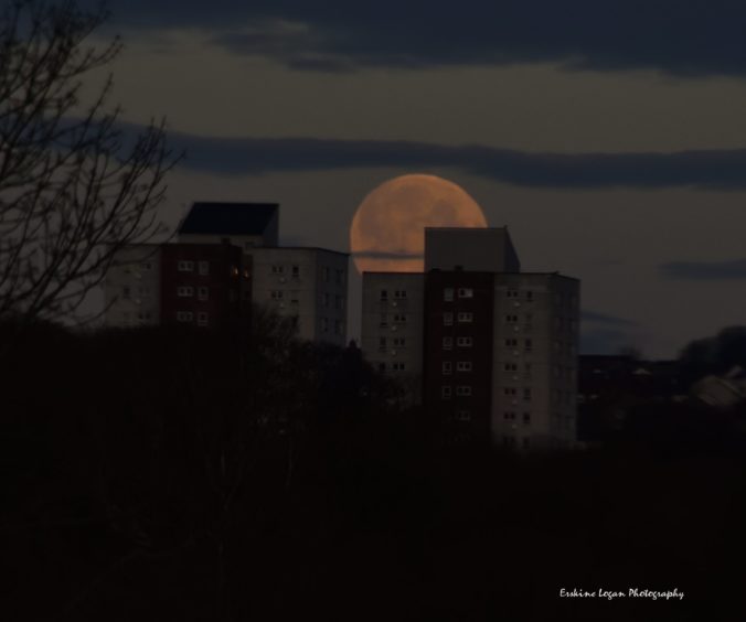 The moon hiding behind the high rise flats of Aberdeen. Picture by Erskine Logan.