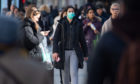 A woman wearing a protective face mask on Oxford Street, central London.