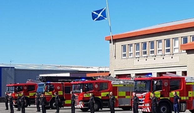 Firefighters stand on parade outside Inverness Fire station in honour of retired Inverness fire chief Derek Wilkie.