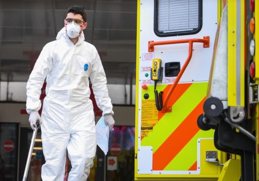 A paramedic wearing personal protective equipment (PPE)outside St Thomas' Hospital in Westminster, London, as the UK continues in lockdown to help curb the spread of the coronavirus.