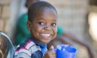 Child eats Mary's Meals in Malawi.