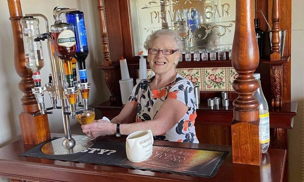Resident and former landlady Eileen Brice is kept busy quenching the thirst of fellow guests
