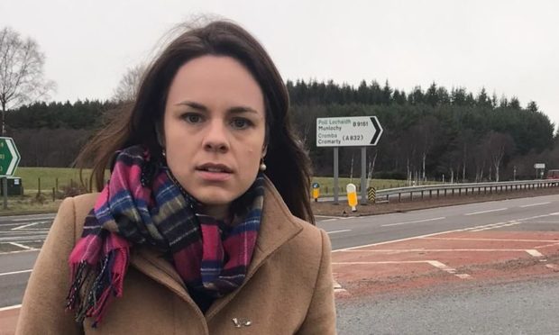 Kate Forbes MSP looking angry while standing at the Munlochy Junction.