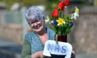 Kathleen Gray from Turriff who along with her husband has been putting out fresh flowers every week in praise of the NHS.
Pic by Chris Sumner